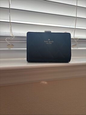 Kate Spade black quilted compact wallet with gold logo